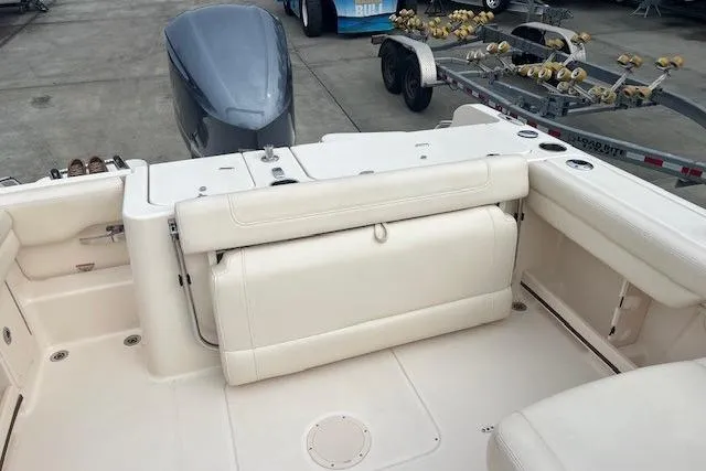 Slide: The Image of 2018 Grady-White Freedom 235 boat interior with seating and motor view. - 23