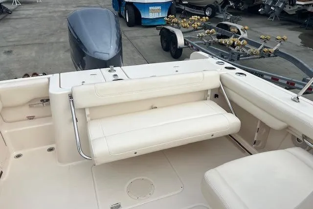 Slide: The Image of 2018 Grady-White Freedom 235 boat interior with foldable seating and engine view. - 24