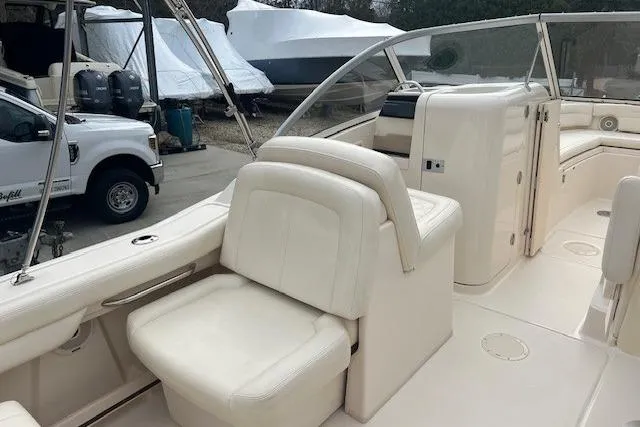 Slide: The Image of 2018 Grady-White Freedom 235 boat interior with white seating and console. - 25