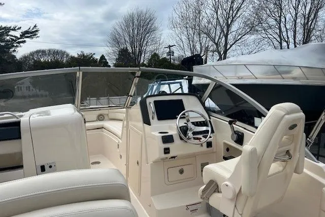 Slide: The Image of 2018 Grady-White Freedom 235 boat interior with steering console and seating. - 26