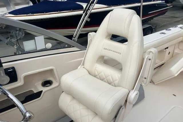 Slide: The Image of 2018 Grady-White Freedom 235 boat interior with white cushioned seating. - 28
