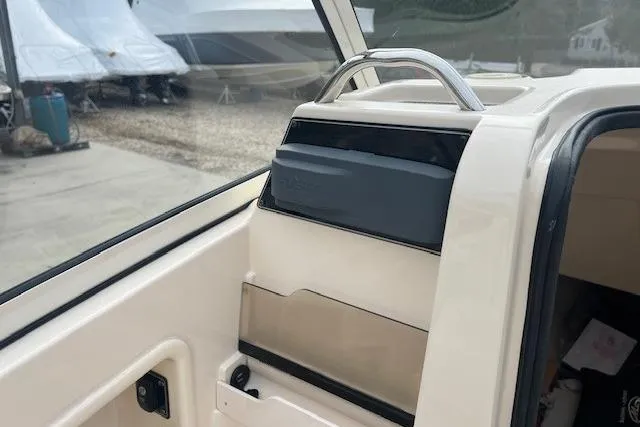 Slide: The Image of 2018 Grady-White Freedom 235 boat interior with storage compartment and handle. - 32