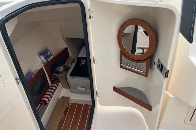 Slide: The Image of 2018 Grady-White Freedom 235 boat interior with storage and wooden accents. - 33