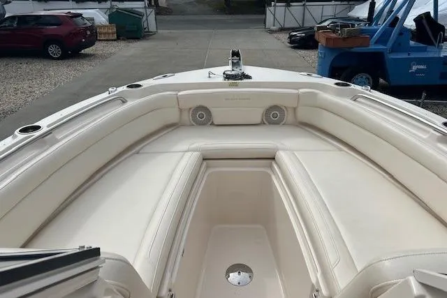 Slide: The Image of 2018 Grady-White Freedom 235 boat interior with beige seating and cup holders. - 34
