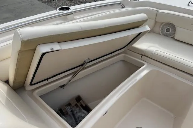 Slide: The Image of 2018 Grady-White Freedom 235 boat storage compartment with open cushioned seat. - 38