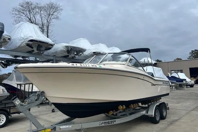 Slide: The Image of 2018 Grady-White Freedom 235 boat on trailer, parked outdoors. - 4