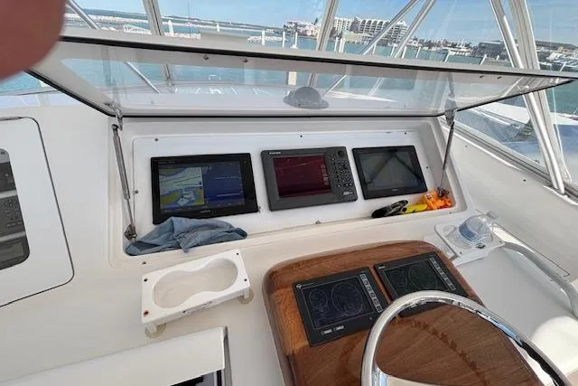 Slide: The Image of Helm of 2007 Viking 52 Convertible yacht with navigation screens and controls. - 10