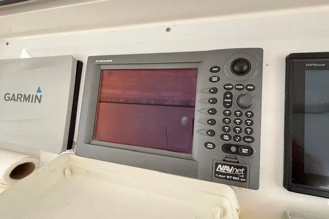 Slide: The Image of Navigation equipment on a 2007 Viking 52 Convertible boat, featuring Furuno and Garmin displays. - 11