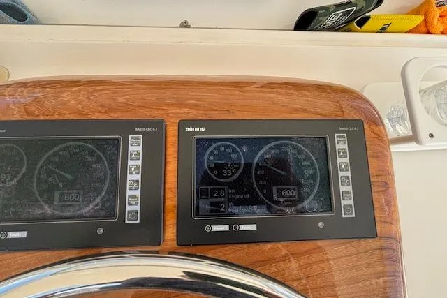 Slide: The Image of Dashboard of a 2007 Viking 52 Convertible yacht with dual electronic displays. - 15