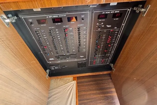 Slide: The Image of Electrical panel inside a 2007 Viking 52 Convertible yacht, showcasing circuit breakers and voltage meters. - 19
