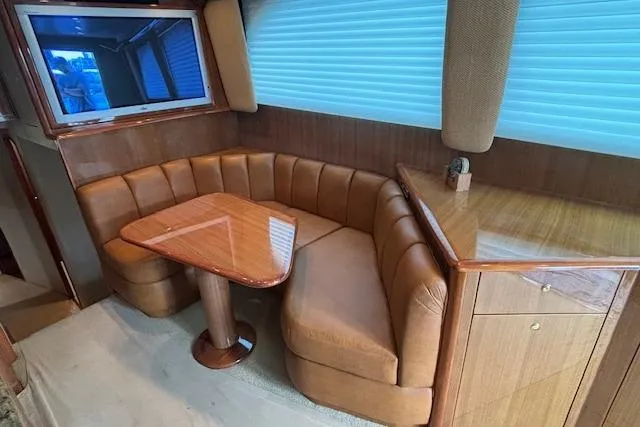Slide: The Image of Luxurious 2007 Viking 52 Convertible yacht interior with leather seating and wooden table. - 20