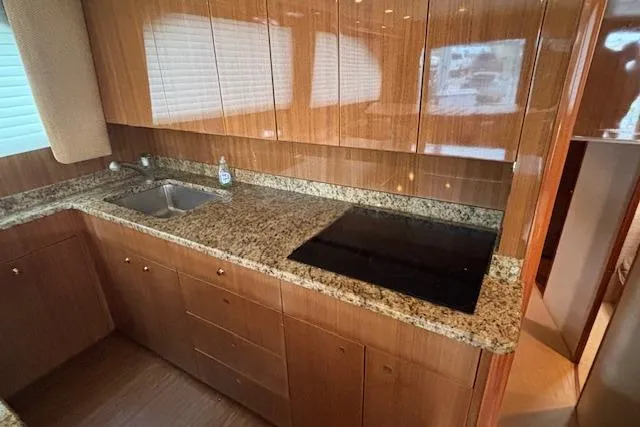 Slide: The Image of Luxurious kitchen in 2007 Viking 52 Convertible yacht with granite countertops and modern appliances. - 22