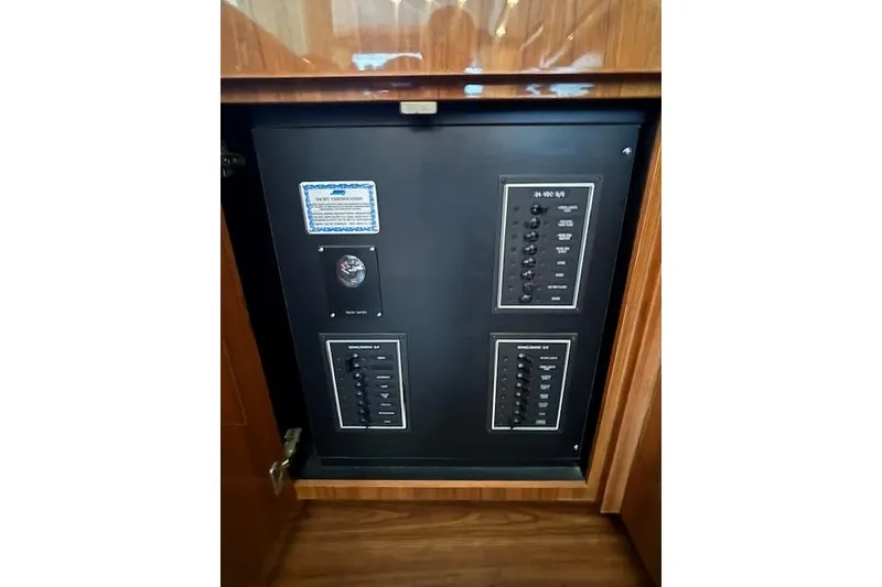 Slide: The Image of Electrical panel inside a 2007 Viking 52 Convertible yacht, featuring switches and controls. - 24