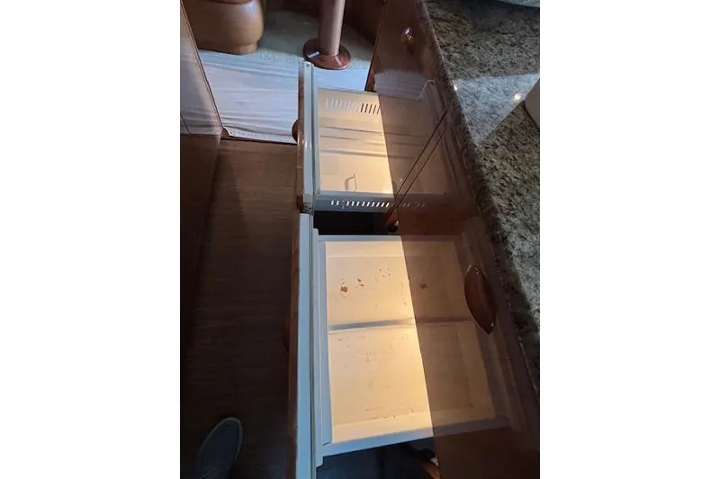 Slide: The Image of Open drawers in a 2007 Viking 52 Convertible yacht kitchen with granite countertop. - 25