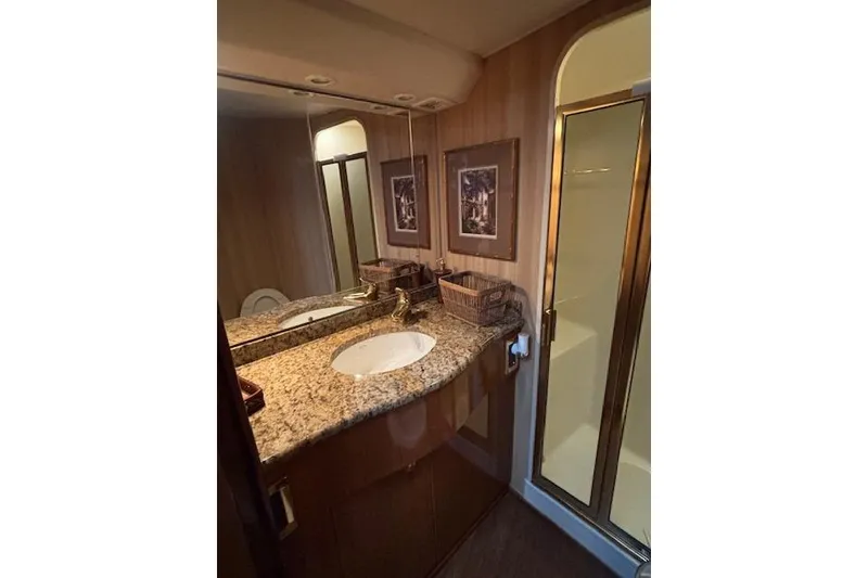 Slide: The Image of Luxurious bathroom in 2007 Viking 52 Convertible yacht with granite countertop and glass shower. - 29