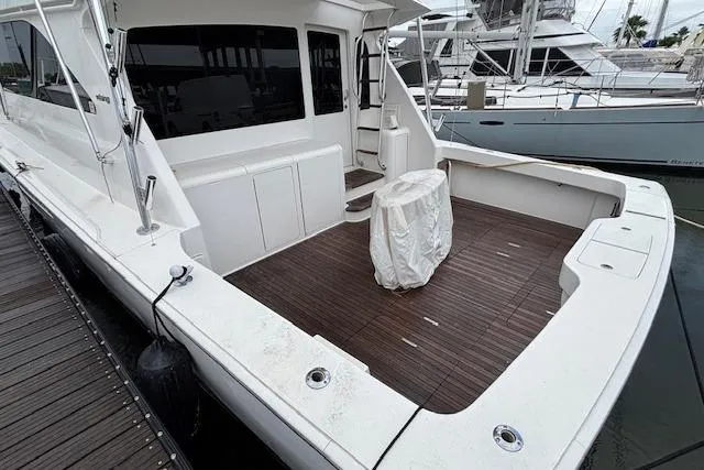 Slide: The Image of 2007 Viking 52 Convertible yacht with spacious deck and covered seating area. - 3