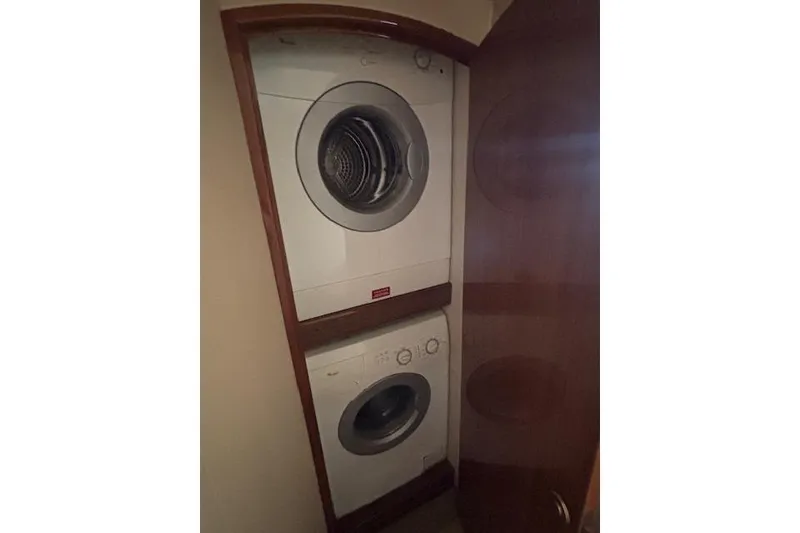 Slide: The Image of Stacked washer and dryer inside 2007 Viking 52 Convertible yacht. - 35