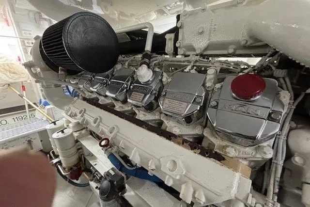 Slide: The Image of Engine room of a 2007 Viking 52 Convertible yacht, showcasing a MAN diesel engine. - 38