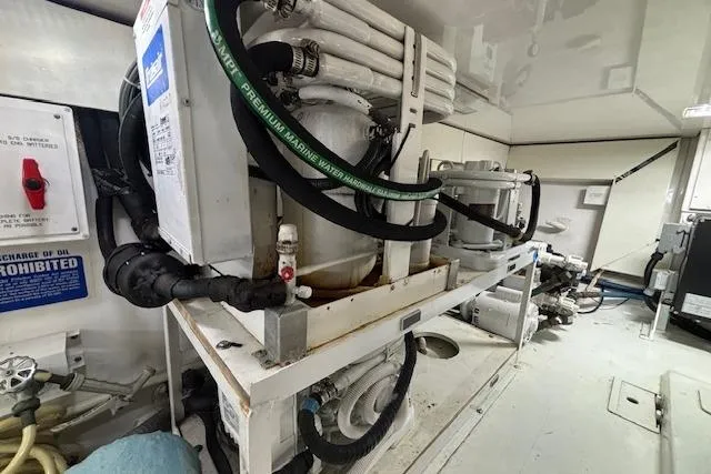 Slide: The Image of Engine room of 2007 Viking 52 Convertible yacht, showcasing mechanical equipment and piping. - 42