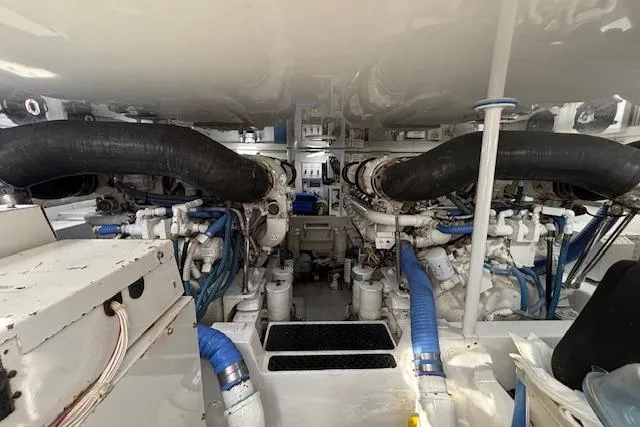 Slide: The Image of Engine room of a 2007 Viking 52 Convertible yacht, showcasing dual engines and piping. - 44