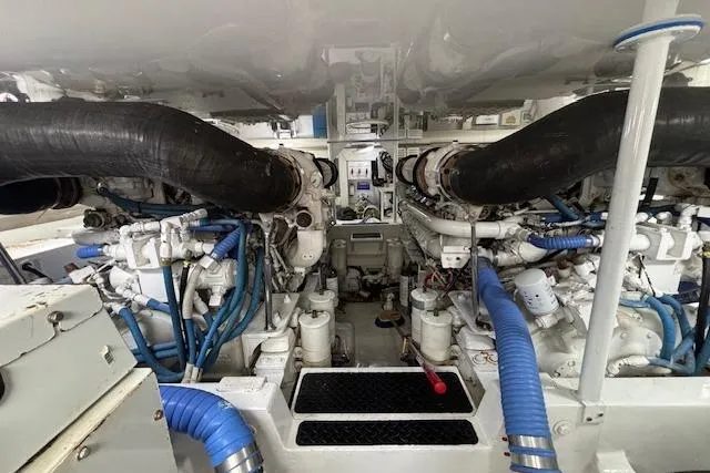 Slide: The Image of Engine room of a 2007 Viking 52 Convertible yacht, showcasing complex machinery and piping. - 45