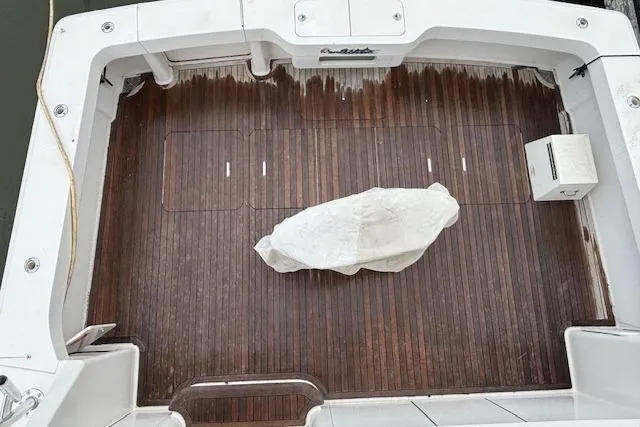 Slide: The Image of 2007 Viking 52 Convertible boat deck with wooden flooring and covered equipment. - 6