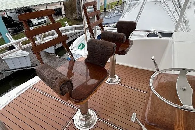 Slide: The Image of 2007 Viking 52 Convertible yacht with polished wooden helm chairs on deck. - 9