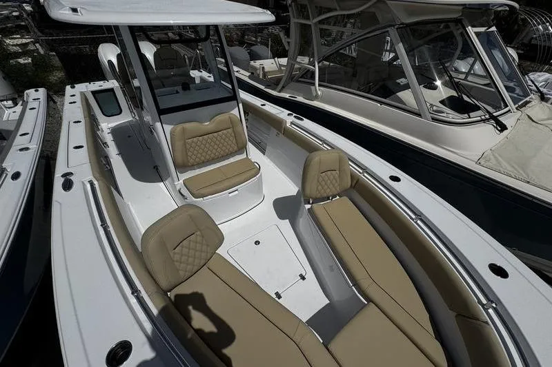 Slide: The Image of 2026 Sportsman Open 262 Center Console boat with tan seating and sleek design. - 11
