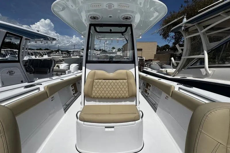 Slide: The Image of 2026 Sportsman Open 262 Center Console boat interior with tan seating and modern design. - 12