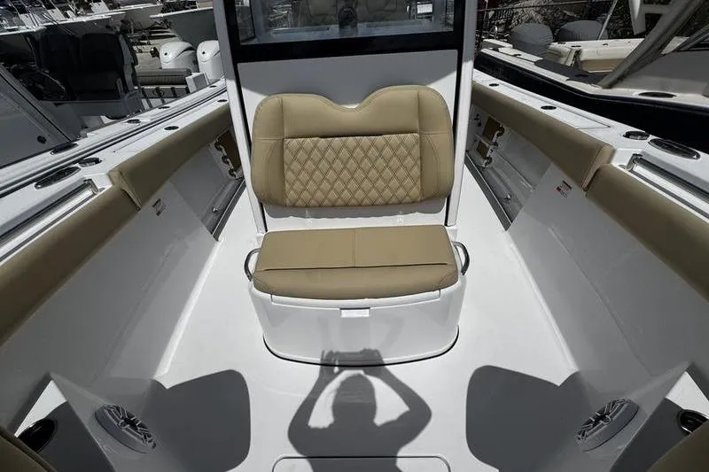 Slide: The Image of 2026 Sportsman Open 262 Center Console boat interior with tan seating and white deck. - 13