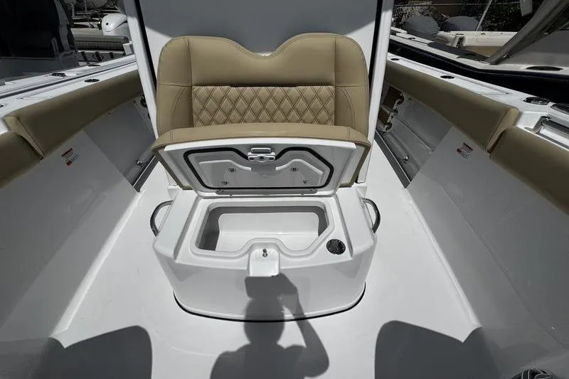 Slide: The Image of 2026 Sportsman Open 262 Center Console boat with open storage compartment and cushioned seating. - 14