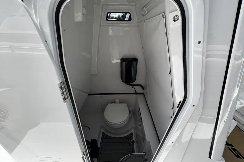 Slide: The Image of Interior of 2026 Sportsman Open 262 Center Console boat's compact bathroom. - 15