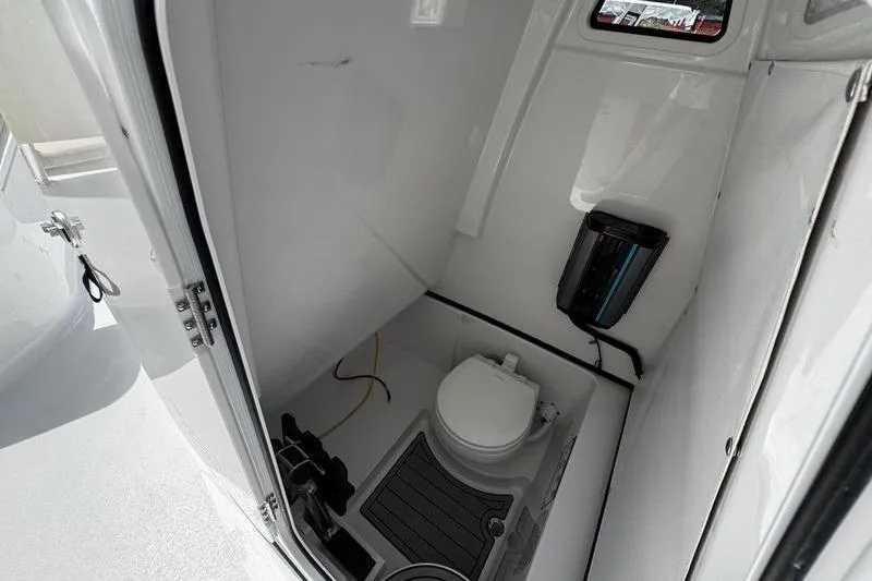 Slide: The Image of Interior of 2026 Sportsman Open 262 Center Console boat's compact bathroom. - 16