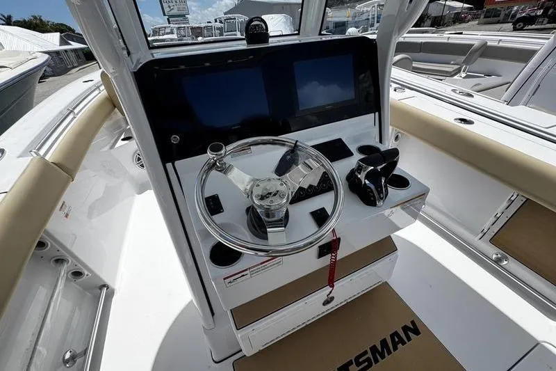 Slide: The Image of 2026 Sportsman Open 262 Center Console boat helm with steering wheel and controls. - 18