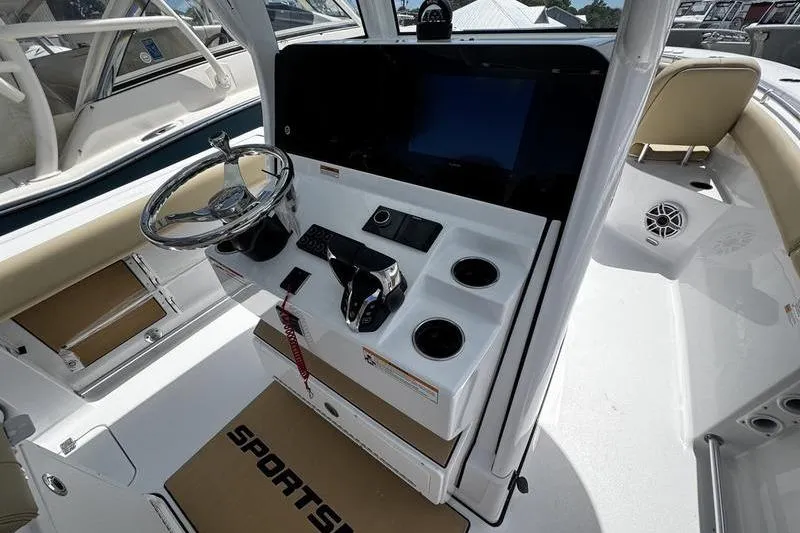 Slide: The Image of 2026 Sportsman Open 262 Center Console boat dashboard with steering wheel and controls. - 19