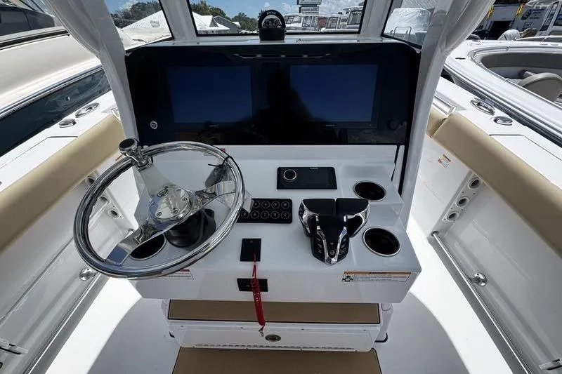 Slide: The Image of 2026 Sportsman Open 262 Center Console helm with dual screens and modern controls. - 20