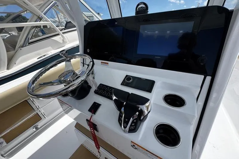 Slide: The Image of 2026 Sportsman Open 262 Center Console dashboard with steering wheel, controls, and cup holders. - 21