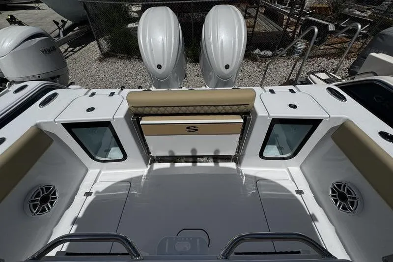 Slide: The Image of 2026 Sportsman Open 262 Center Console boat interior with dual engines and seating. - 25