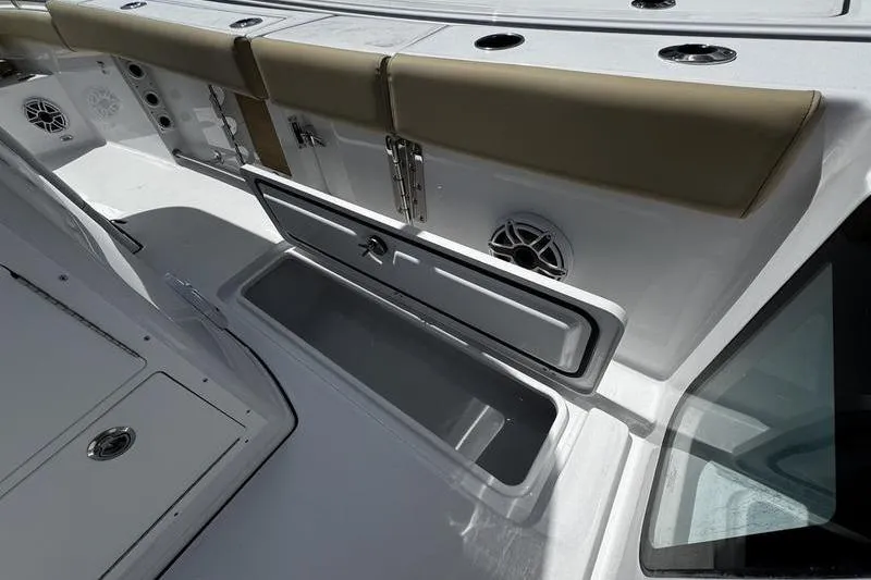 Slide: The Image of 2026 Sportsman Open 262 Center Console boat interior with storage compartment and seating. - 26