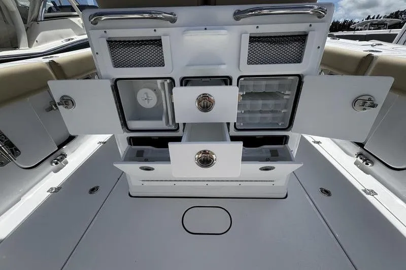 Slide: The Image of 2026 Sportsman Open 262 Center Console boat storage compartments and drawers open for viewing. - 28