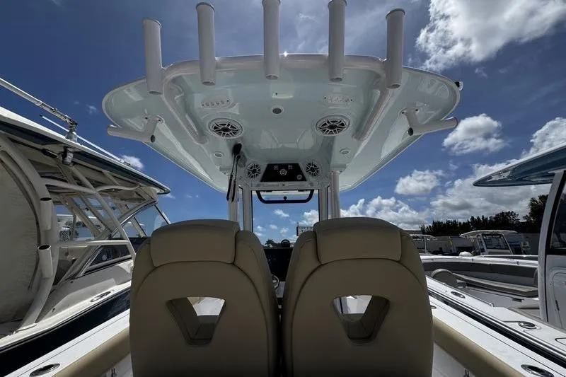 Slide: The Image of 2026 Sportsman Open 262 Center Console boat interior with dual seats and overhead rod holders. - 29