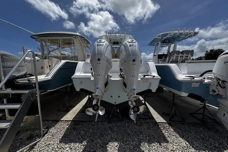 Slide: The Image of 2026 Sportsman Open 262 Center Console with dual outboard engines, displayed outdoors. - 31