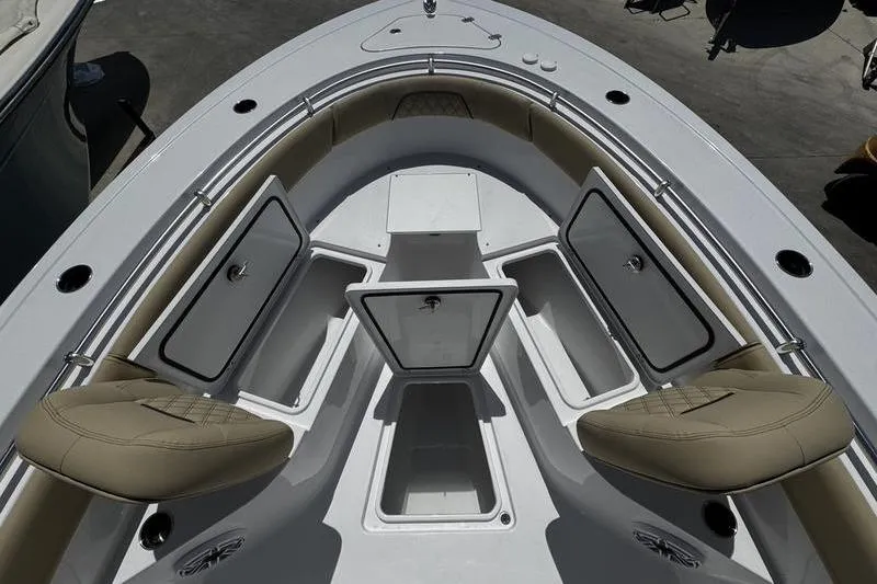 Slide: The Image of 2026 Sportsman Open 262 Center Console boat with open storage compartments and seating. - 7