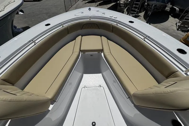 Slide: The Image of 2026 Sportsman Open 262 Center Console boat with tan cushioned seating. - 8