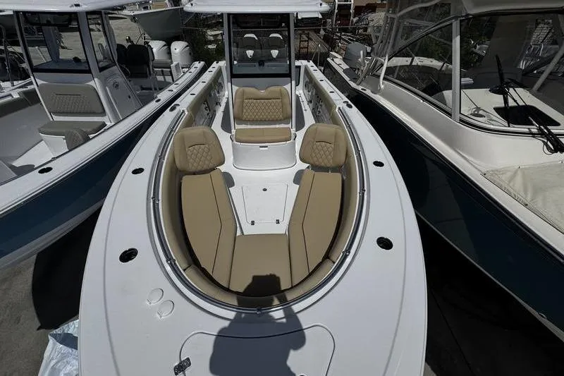 Slide: The Image of 2026 Sportsman Open 262 Center Console boat with tan seating and sleek design. - 9