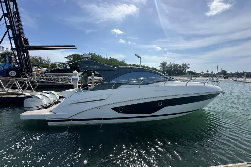 Slide: The Image of 2022 Schaefer 400 Sport yacht docked, featuring sleek design and twin Suzuki engines. - 1