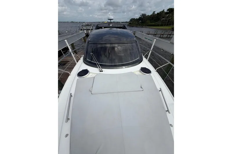 Slide: The Image of 2022 Schaefer 400 Sport yacht docked, showcasing sleek design and spacious deck. - 16