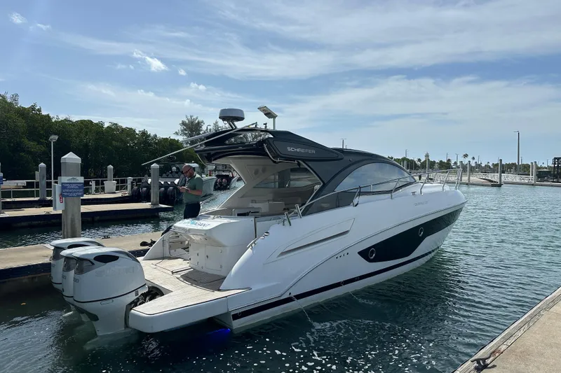 Slide: The Image of 2022 Schaefer 400 Sport yacht docked at marina with clear skies. - 2