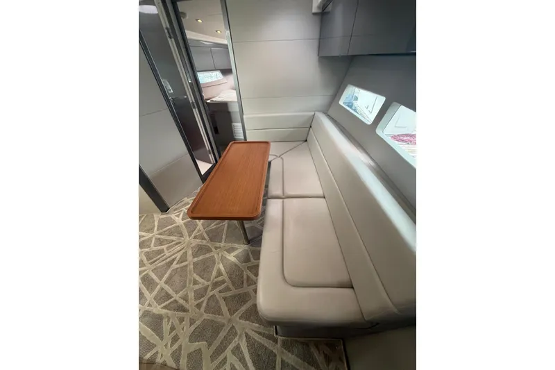 Slide: The Image of Interior of 2022 Schaefer 400 Sport yacht with modern seating and wooden table. - 20