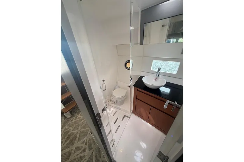 Slide: The Image of 2022 Schaefer 400 Sport yacht bathroom with modern sink, toilet, and window. - 23